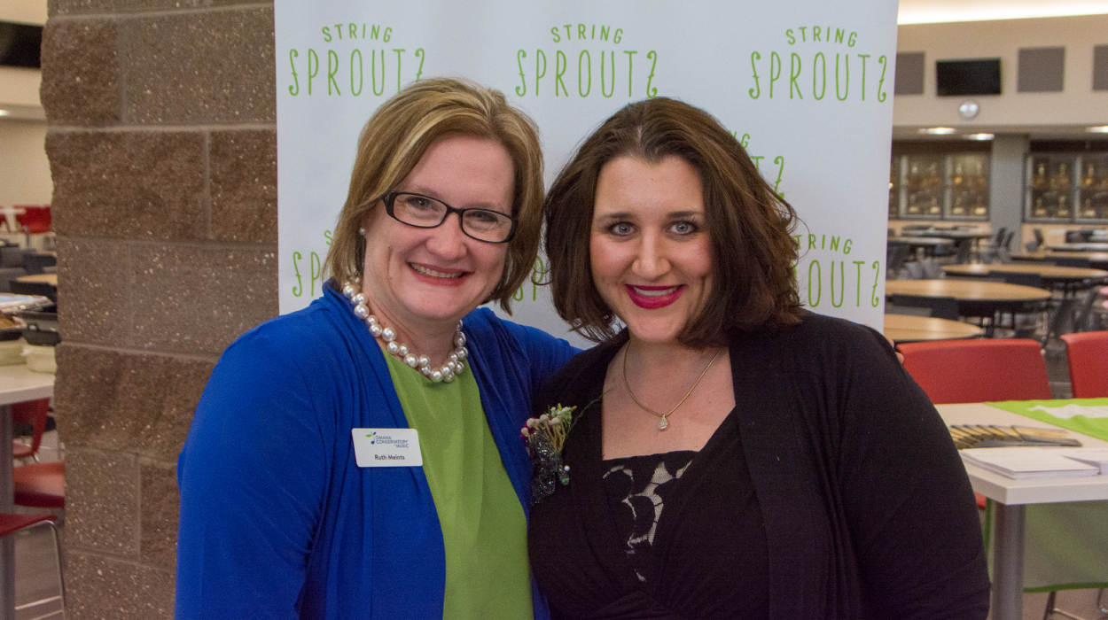 String Sprouts founder Ruth Meints and Scottsbluff lead teacher Ashley Hillman smile for the camera during an event in 2018.